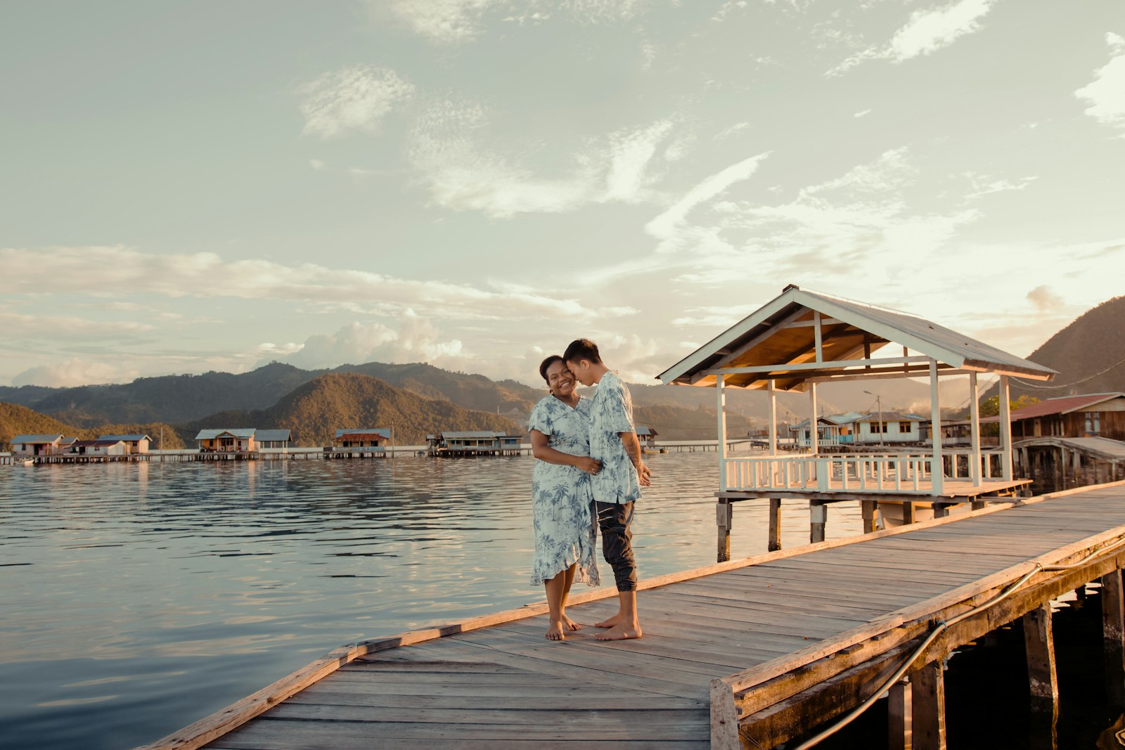 woman in white shirt standing on wooden dock during daytime